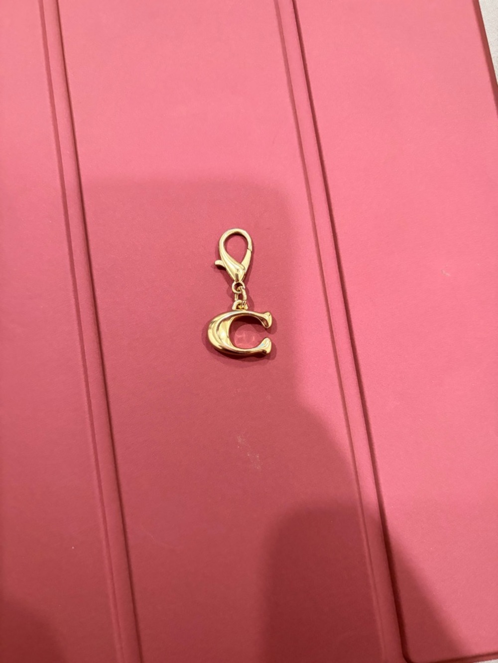 Coach Gold 'C' Charm Key/Bag Clip on Pink Background